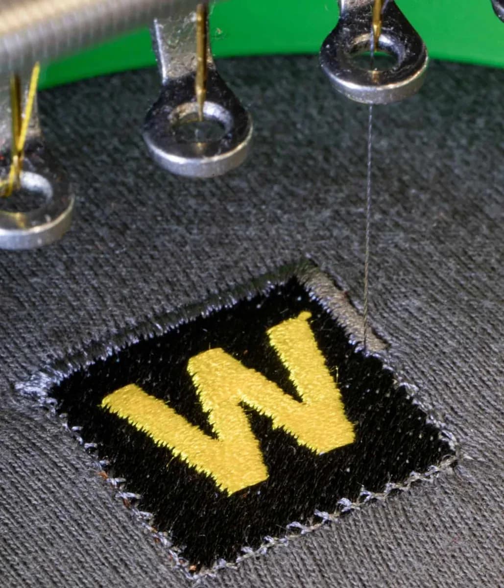 Industrial embroidery machine stitching company logo onto workwear — embroidery Romford
